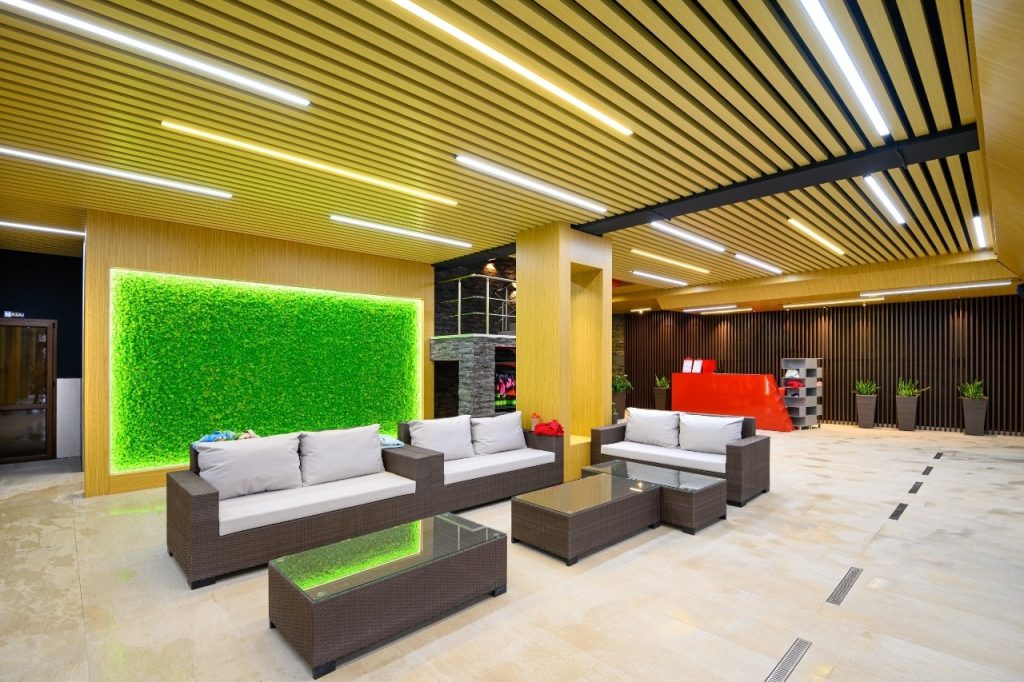 Beautiful interior of relax and spa area with chairs and sofa nearby the swimming pool